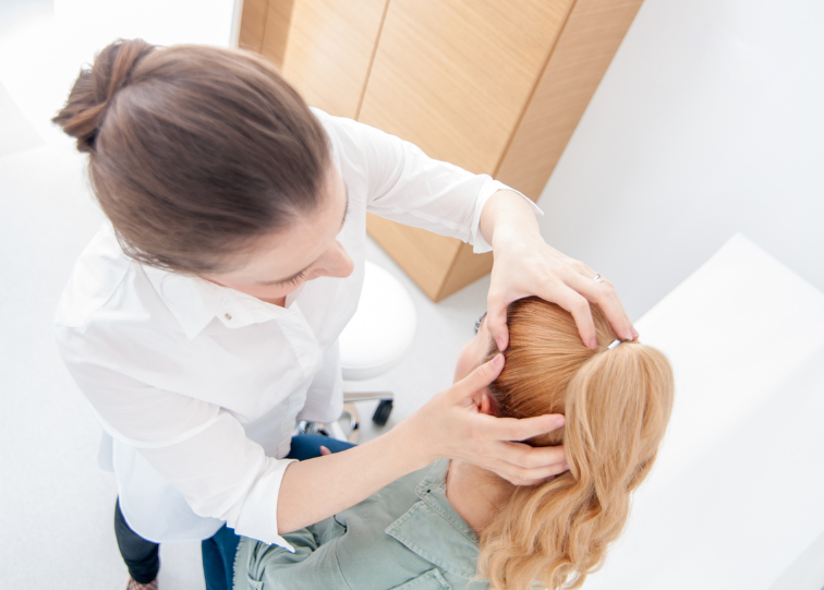 doctor performing trichoscopy serves as a non-invasive diagnostic examination for assessing scalp and hair follicle conditions