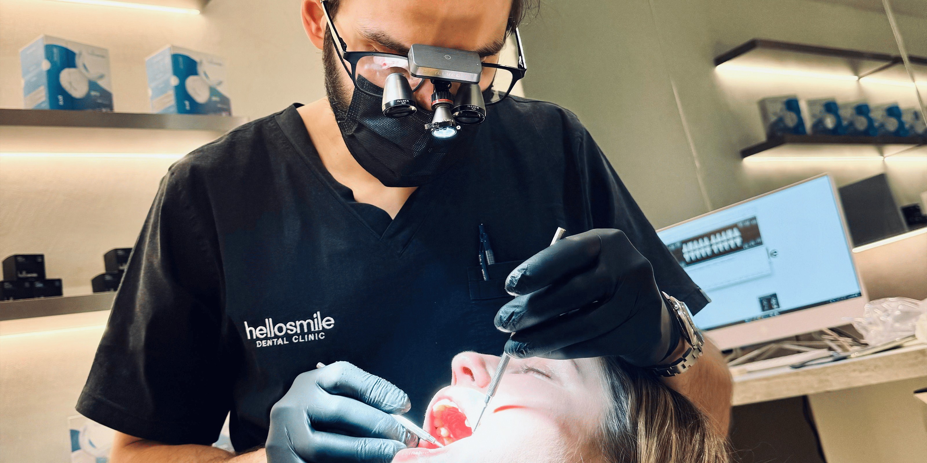 Dental professional performing a procedure on a patient in a clinic setting.