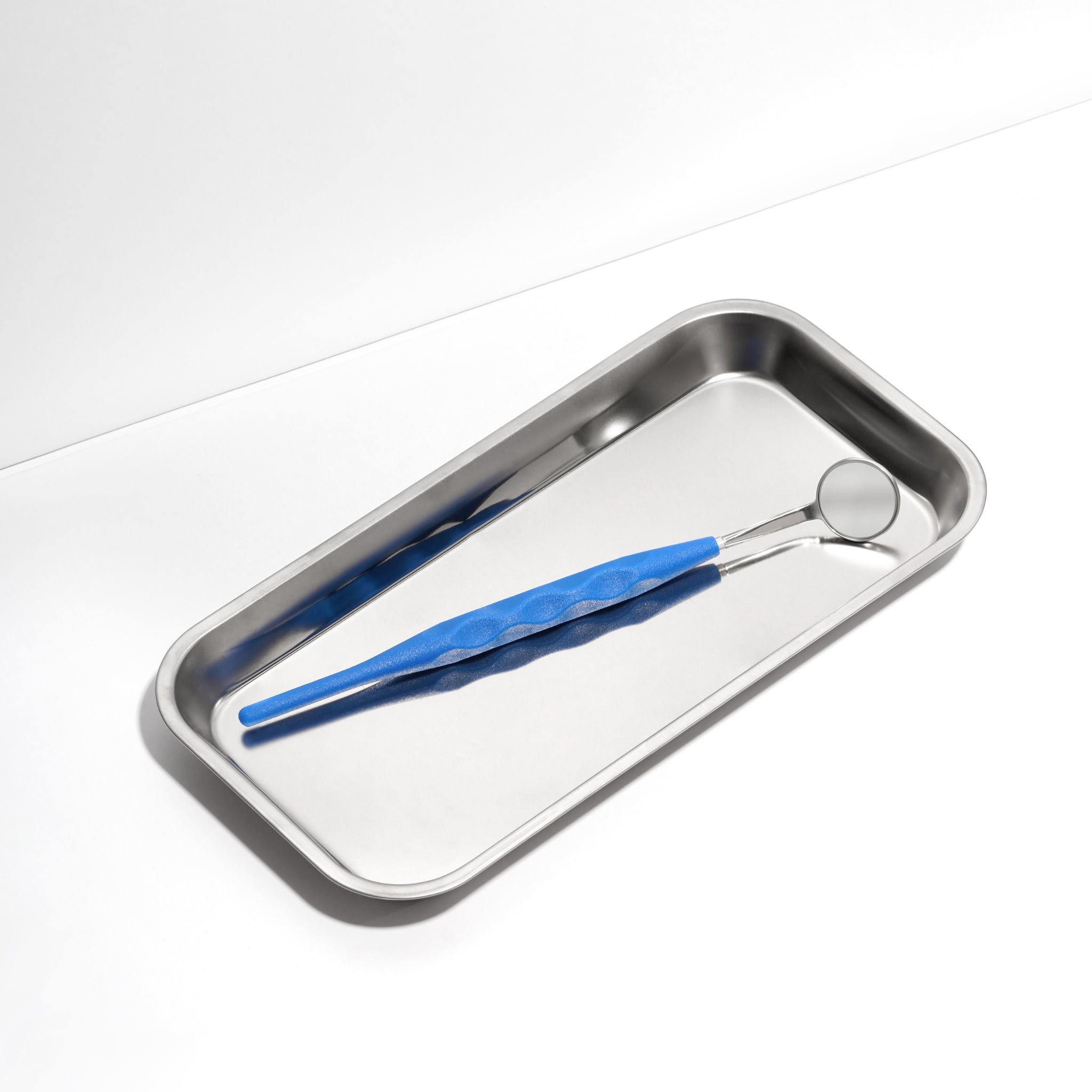 Stainless steel tray with an ILLUCO Dental Mirror on a white background