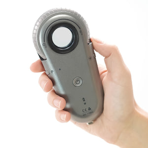 IDS-1100C Dermatoscope in hand showing the back view