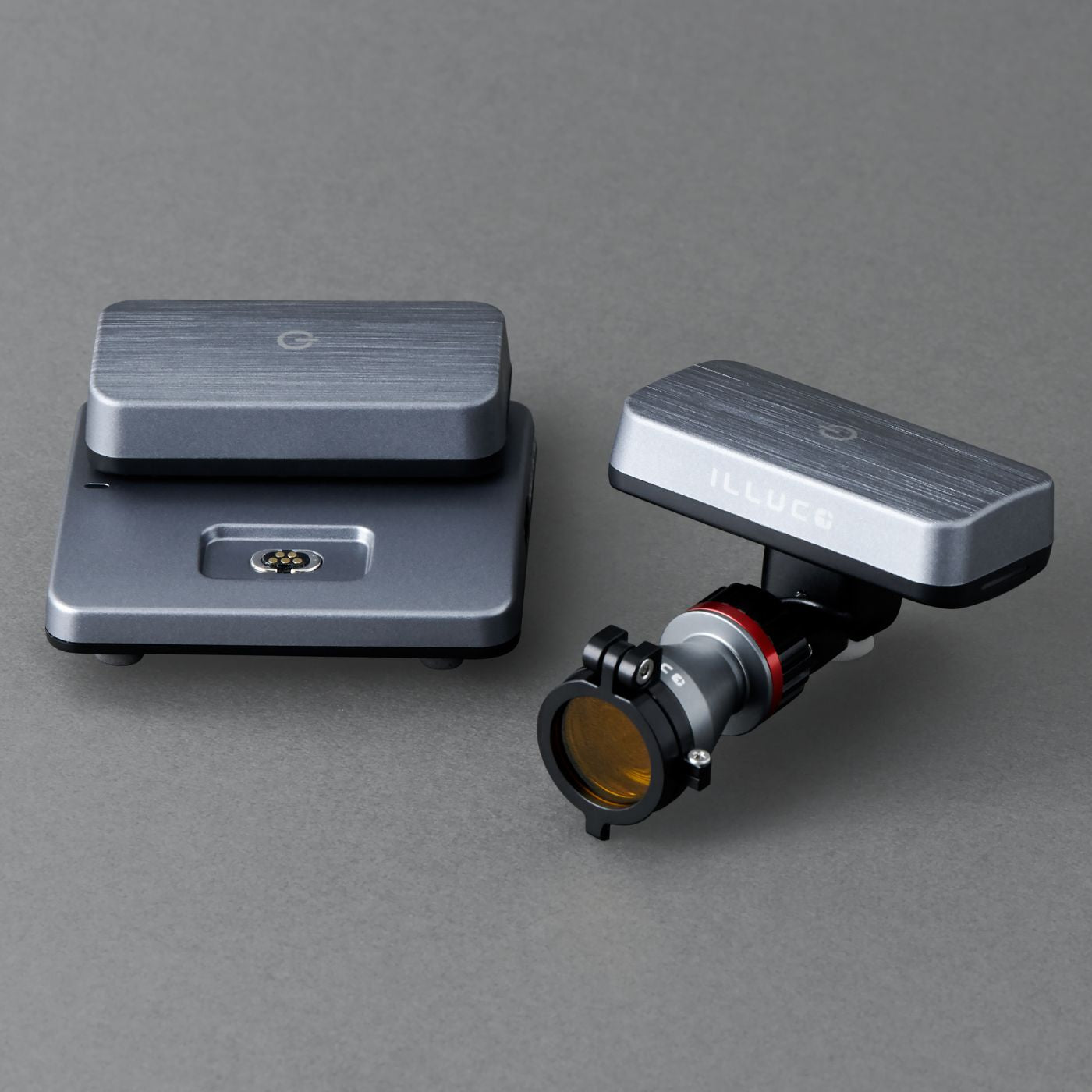 ILLUCO wireless headlight with its two batteries and charging dock