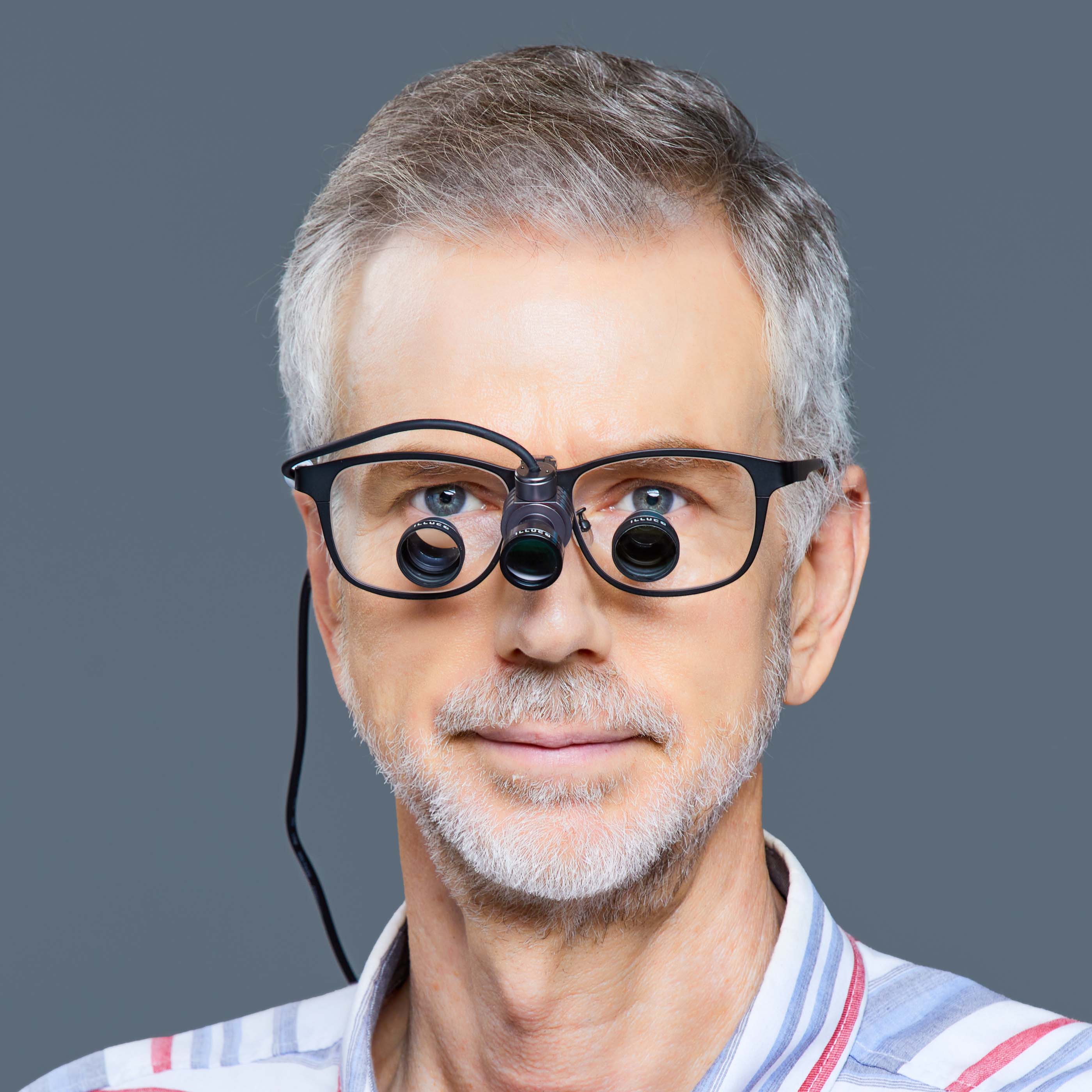 ILLUCO headlight attached to a loupe a doctor wearing the loupe and the headlight