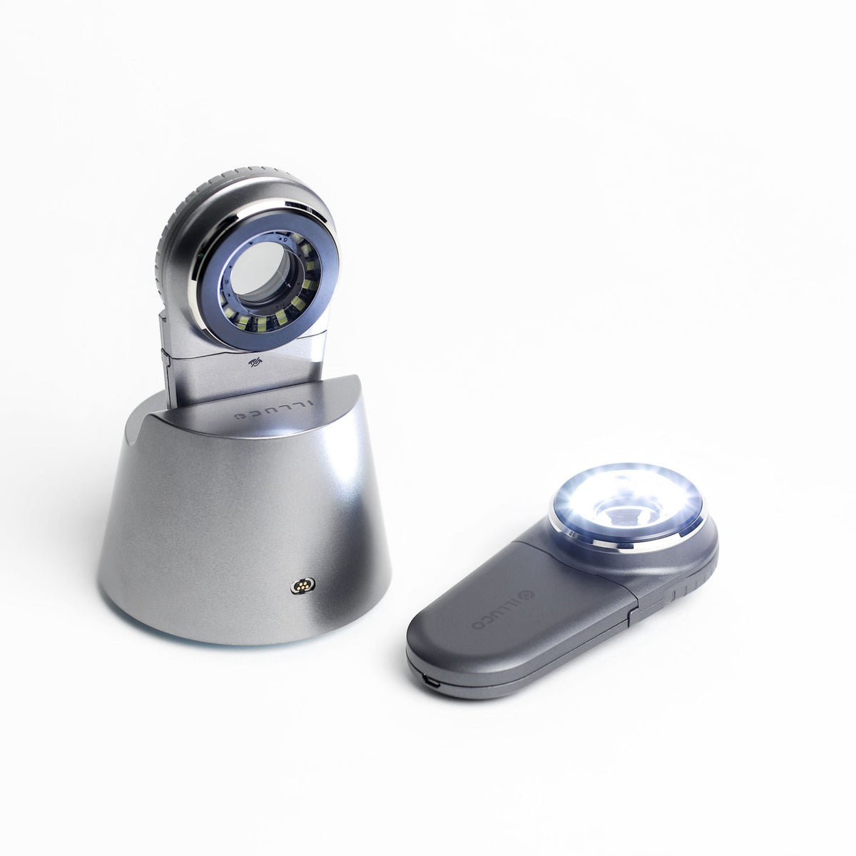 Two IDS-1100C Dermatoscope with light on in and out of the cradle Main image